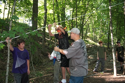Campers using the low ropes Trust Course