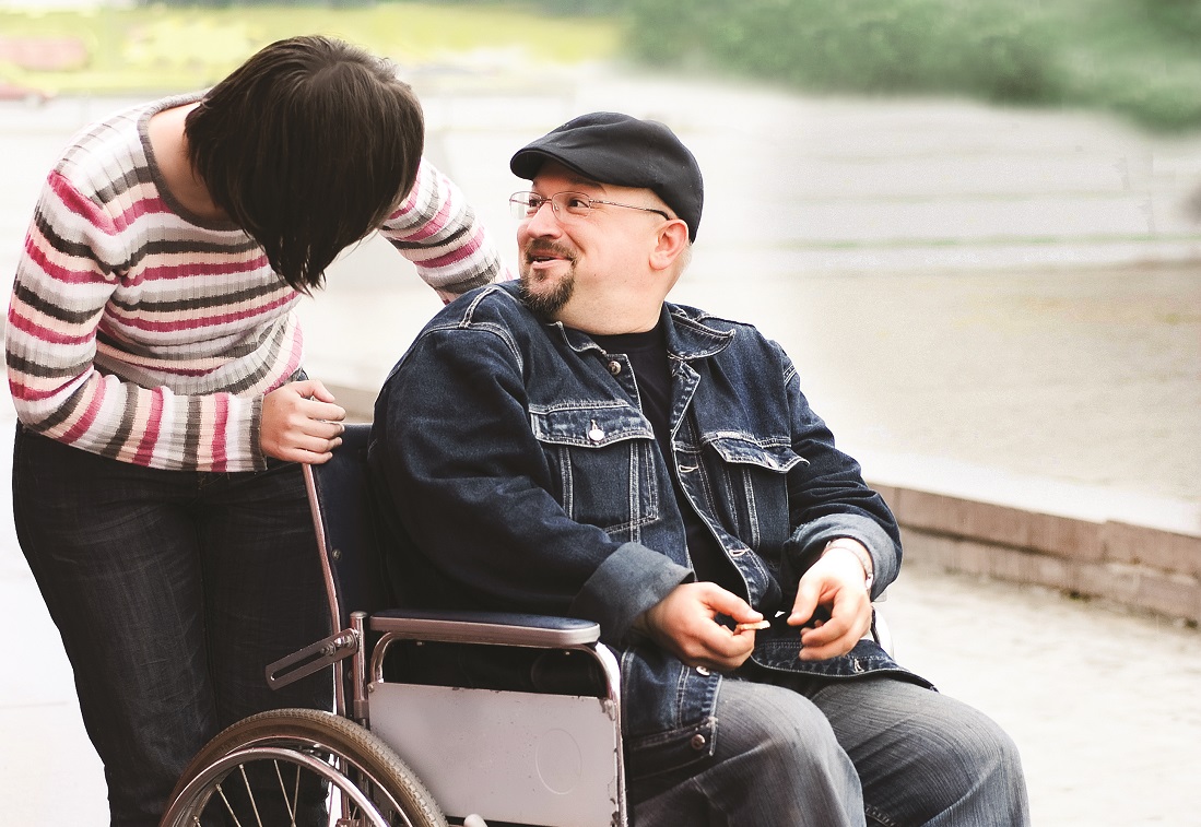 woman smiling at man in wheelchair