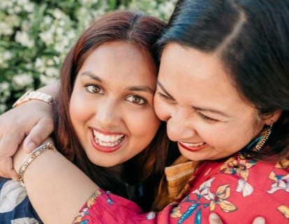 Two smiling women embracing