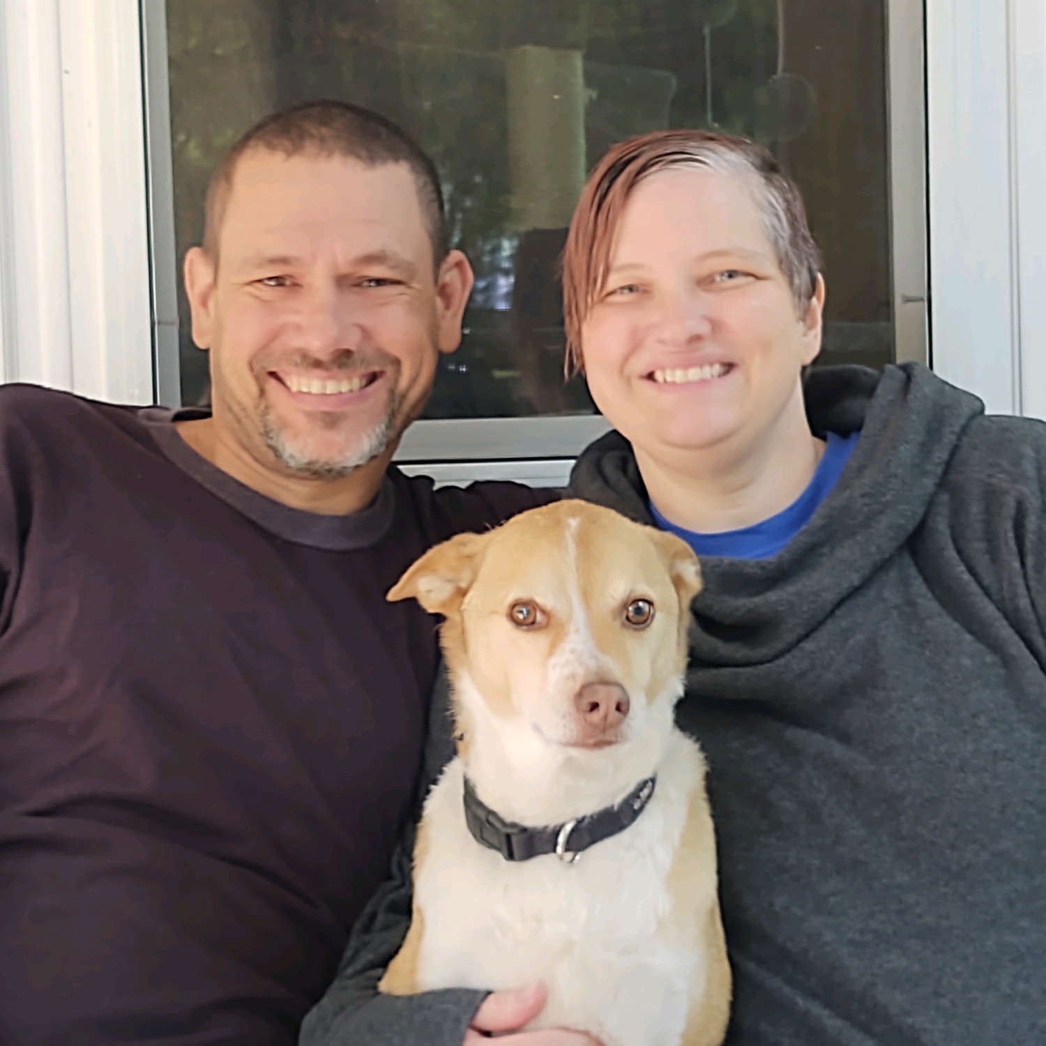 Picture of Aaron and Sheri Tesch with their dog.